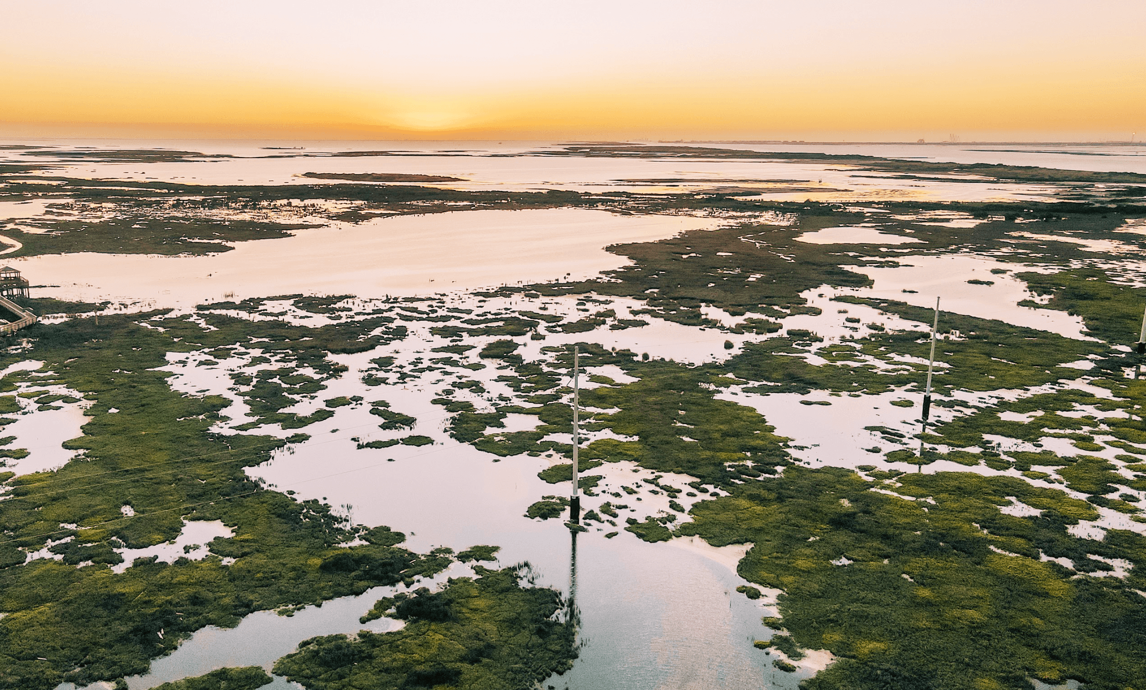 Port Aransas coastal aerial at sunset — marshes and Gulf Coast